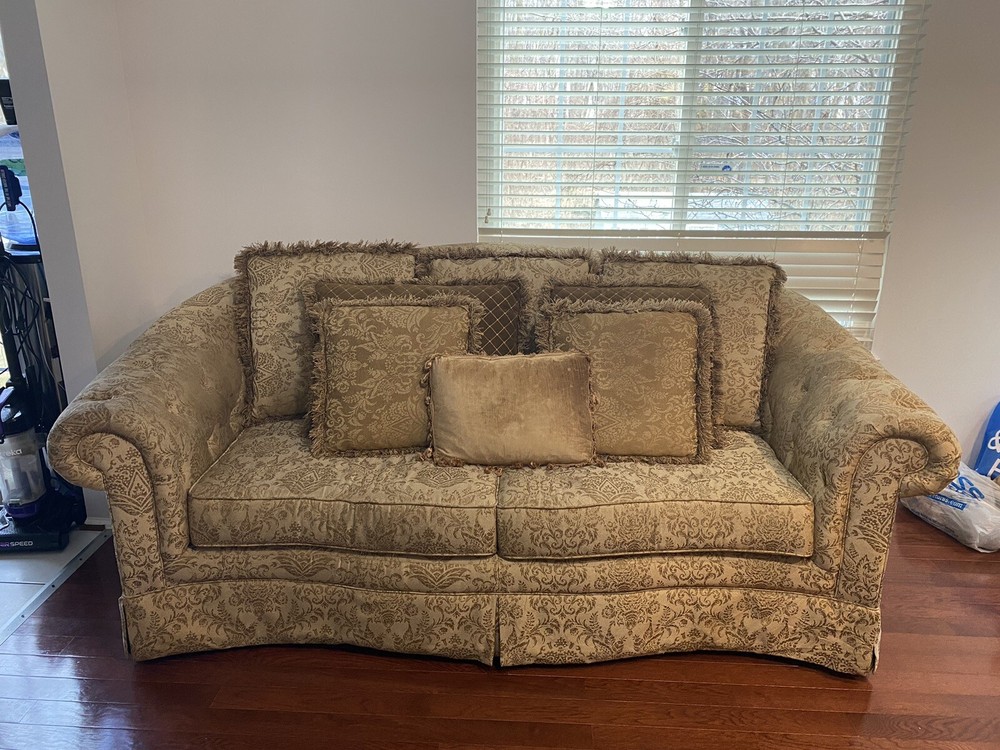 A Set Of Beige Sofas And A Coffee Table