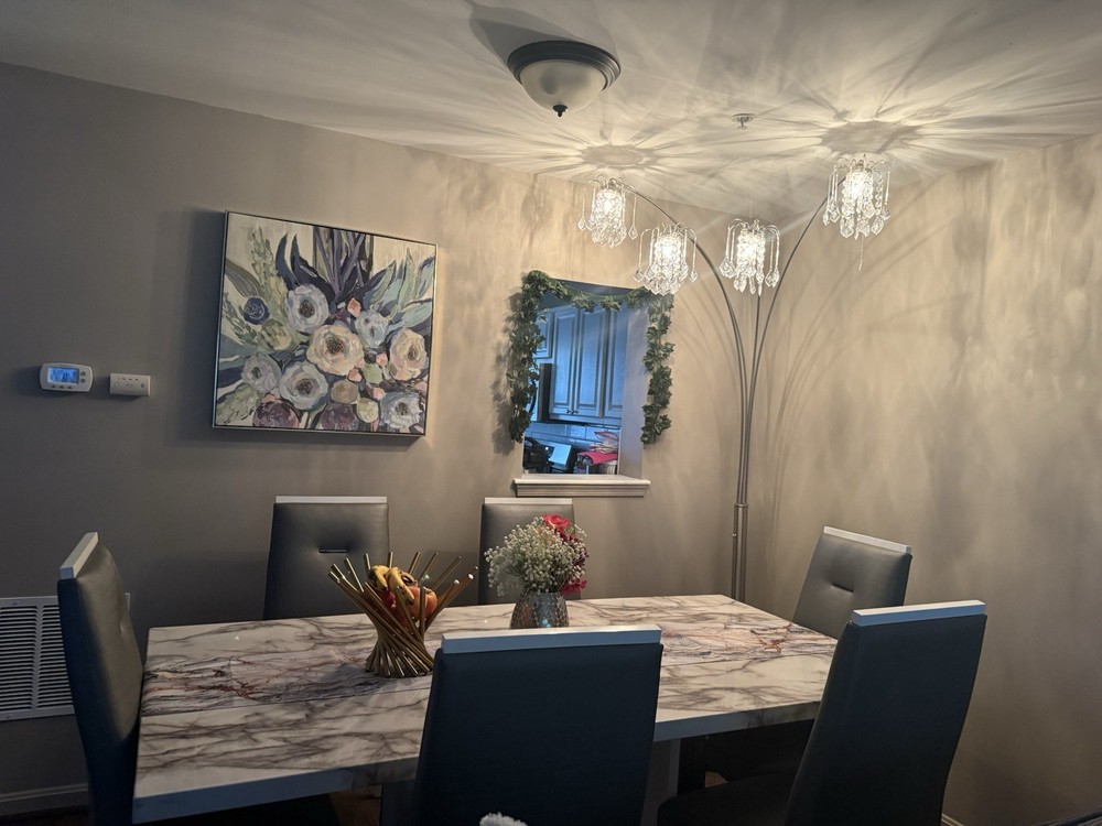 Marble Dining Table with 6 Gray Chairs and Beautiful Buffer with LED lights.