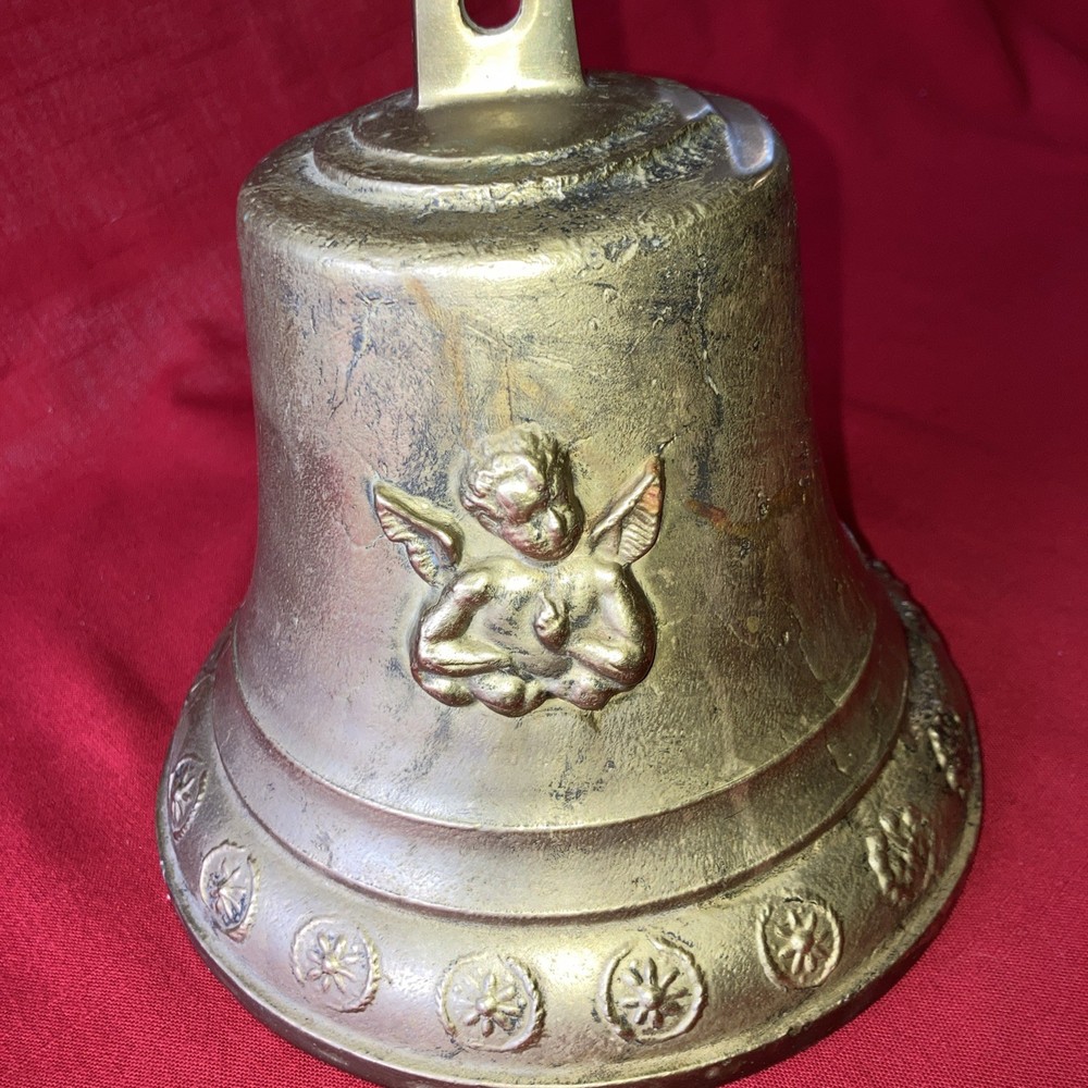 Heavy brass bell with Cupid on each side.