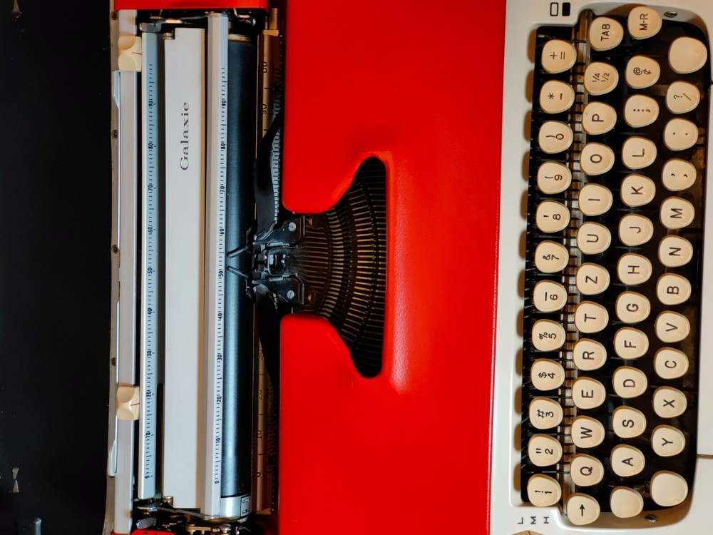 red, portable Smith Corona Galaxie typewriter with Cursive / Handwritten Script