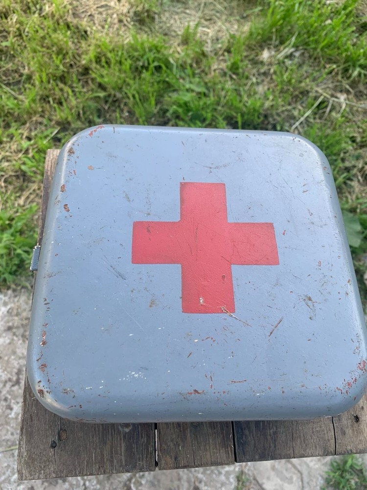 Old Soviet first aid kit with military equipment.