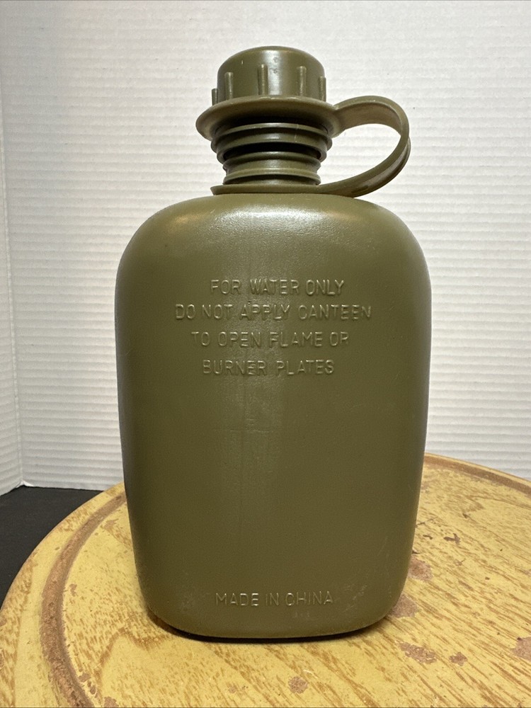 8" Green Plastic Canteen with Cloth Cover.