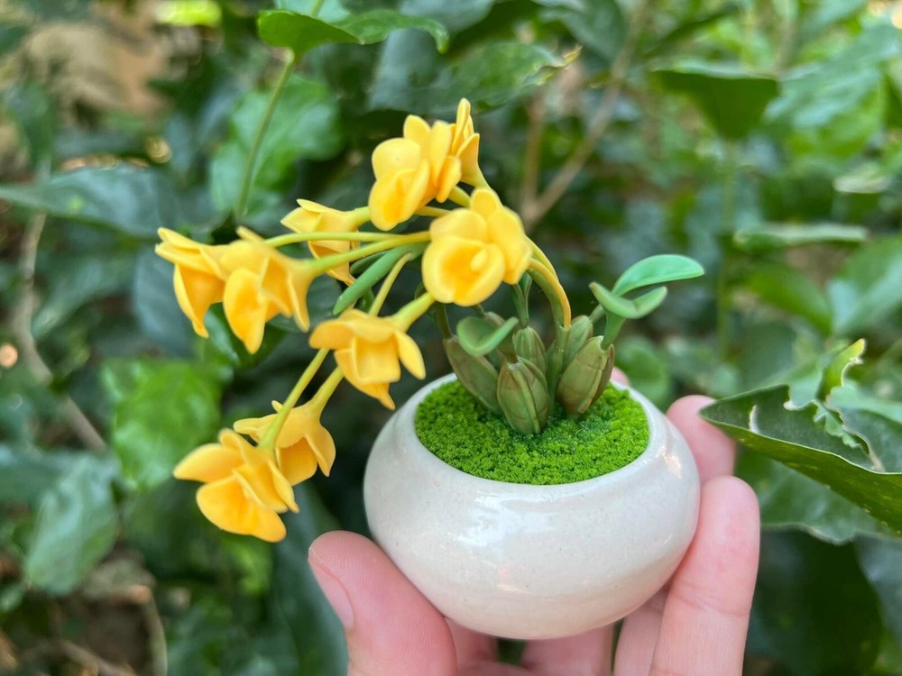 Tiny yellow orchids made by hand from clay