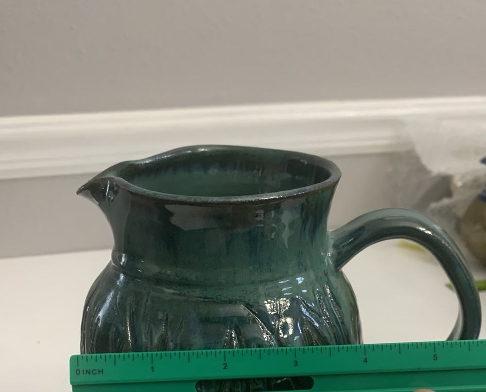 Signed Handcrafted Pottery Pitcher W/ Teal Green Glaze & Raised Leaf Pattern