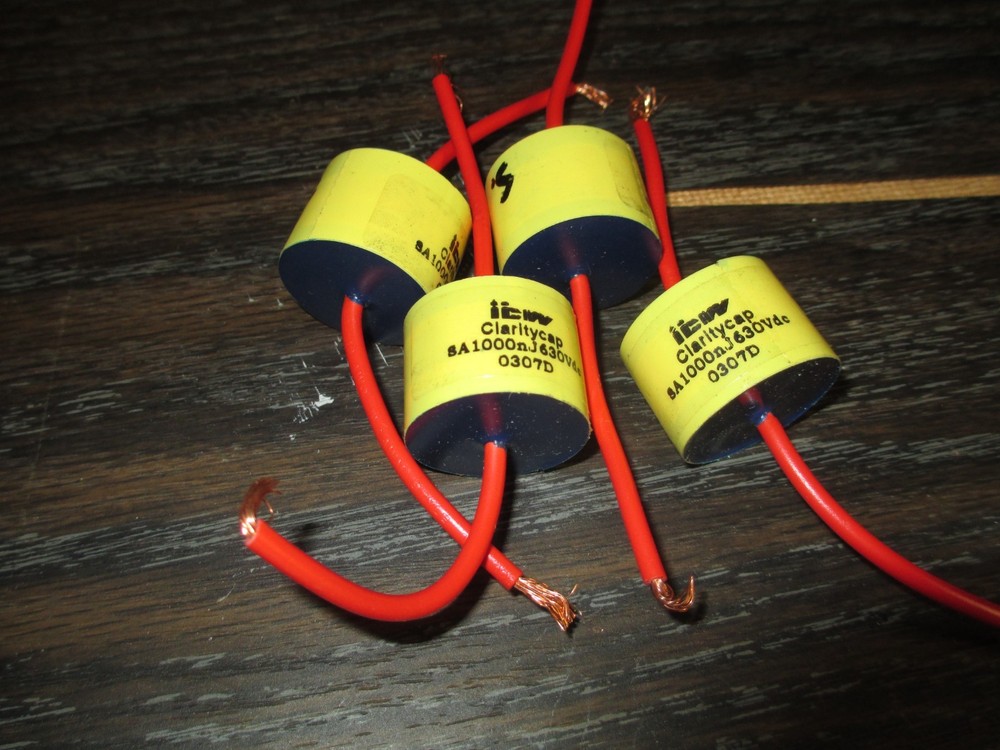 four ClarityCap SA capacitors,  1000 nF,