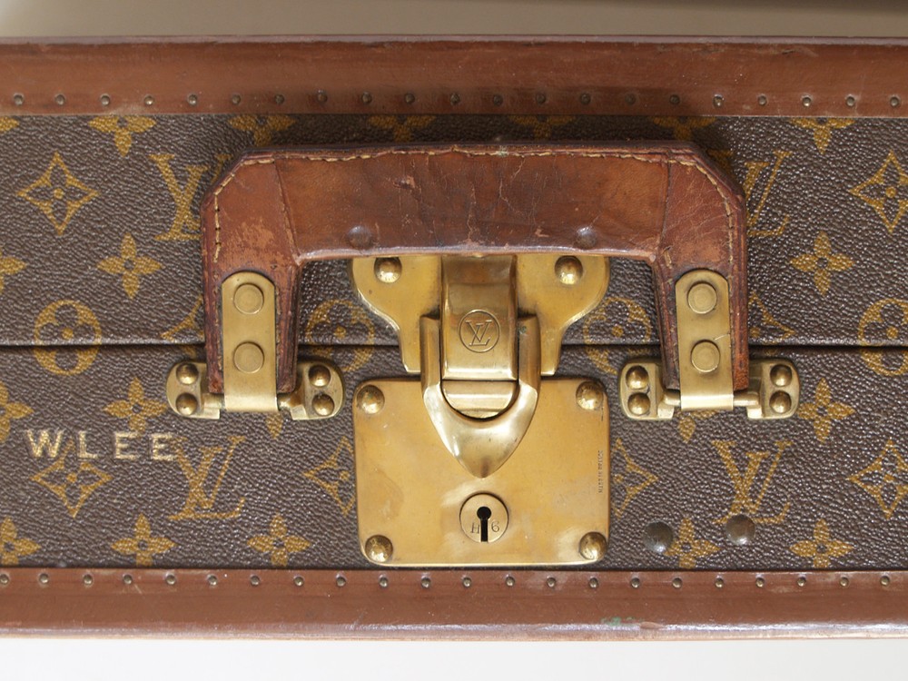 Louis Vuitton monogram suitcase trunk open by center, square handle.
