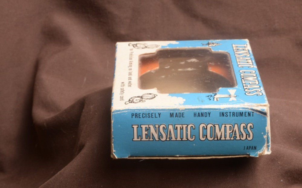two lensatic compasses one with box