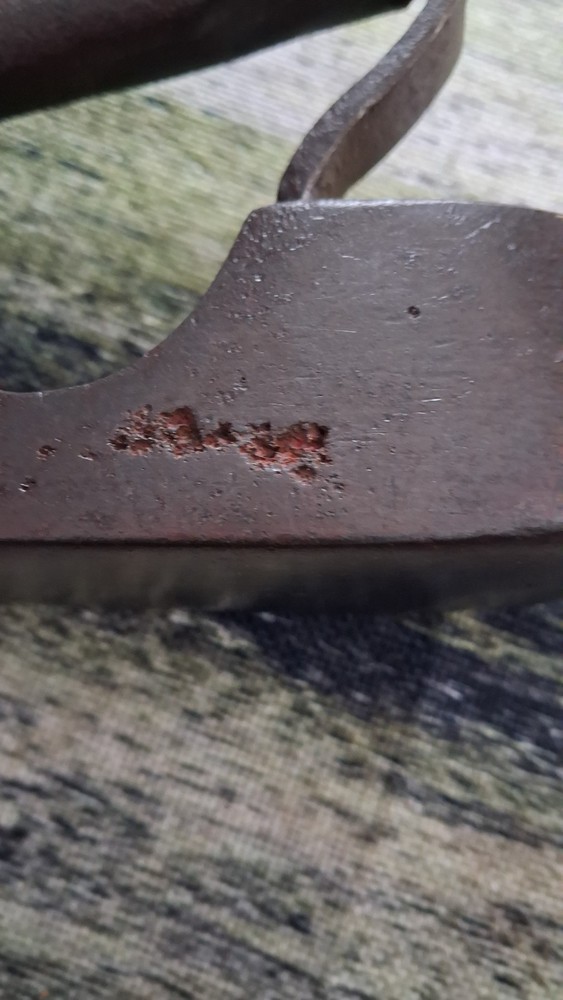 Antique 19th-century cast iron flat iron with a solid handle.