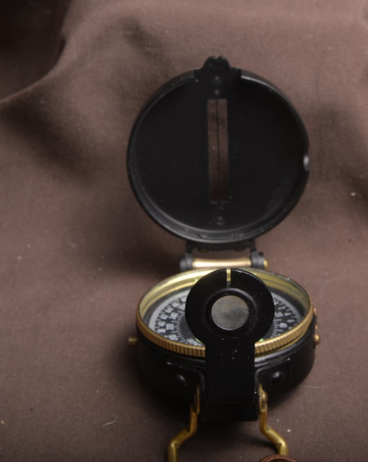 two lensatic compasses one with box