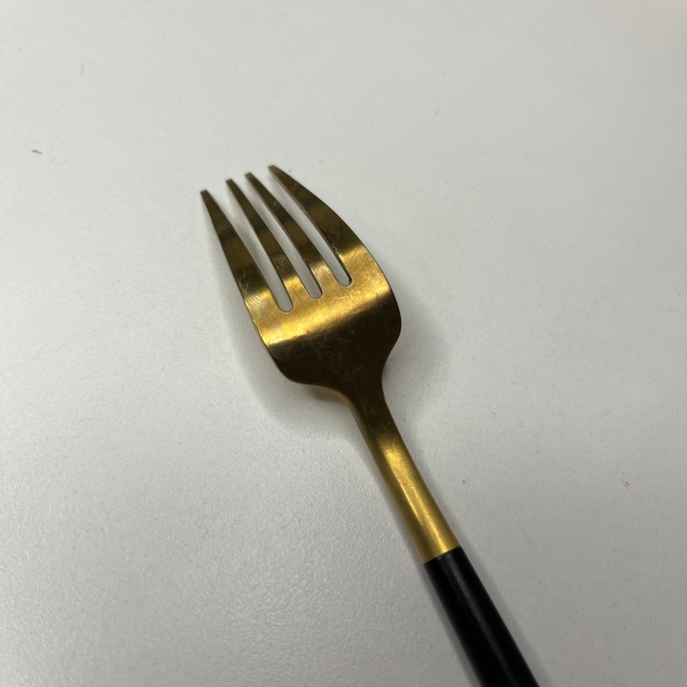 Gold Tone Fork With Matte Black Rounded Handle Modern And Elegant