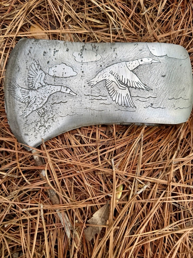 Single Bit Axe With A Duck Scenery Etched On Both Sides.