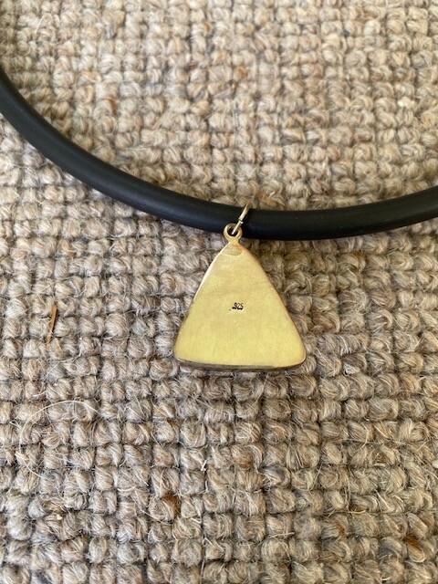 jasper triangular pendant set into silver, on a rubber necklace (Germany)