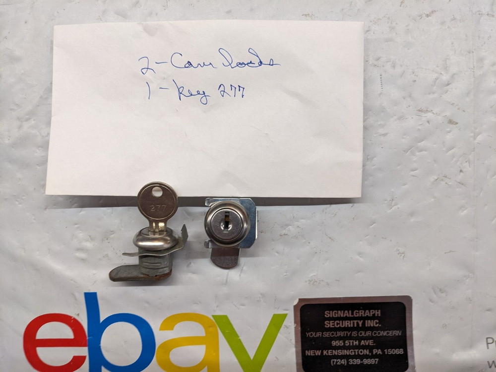 two alarm panel cabinet locks & one key. #277 from alarm panel.