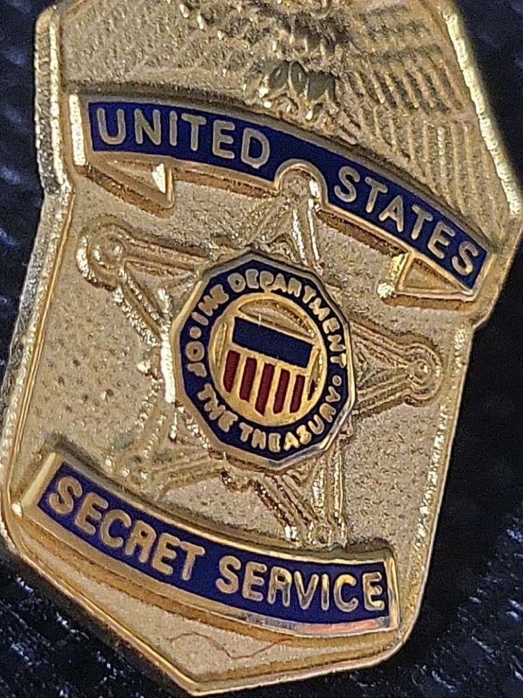 Secret Service Pins A Car And A Shield