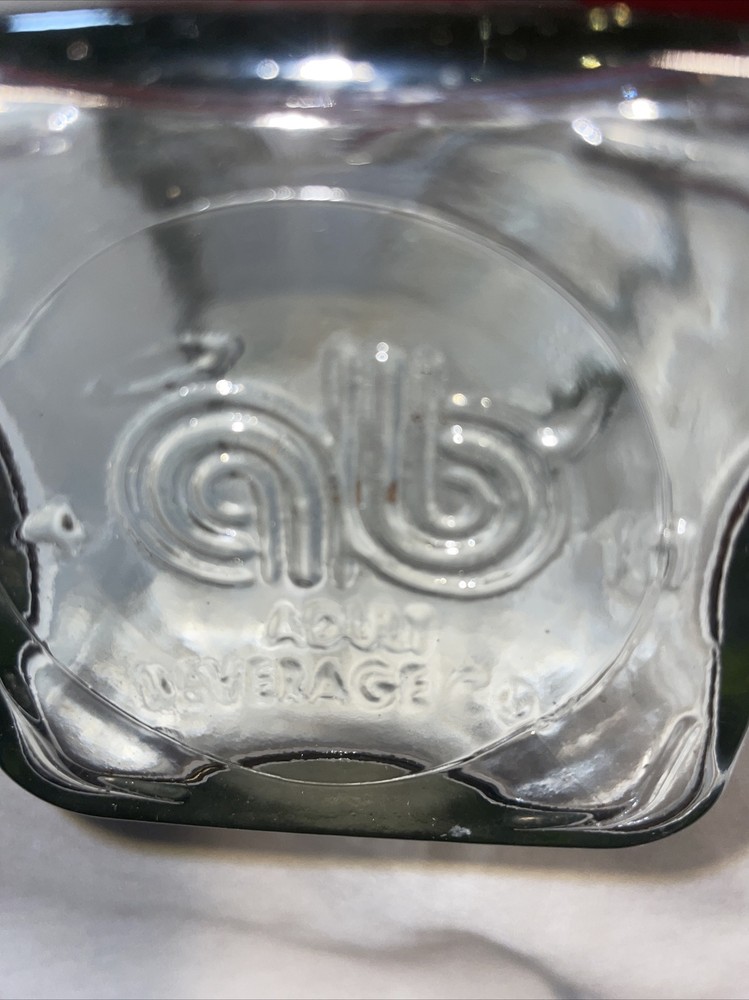 Clear bottle with latch lid- bottom has a b on it