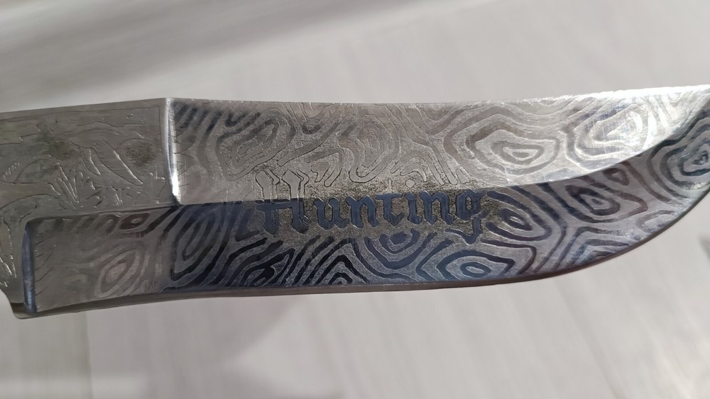 Antique handmade hunting knife with a pattern.