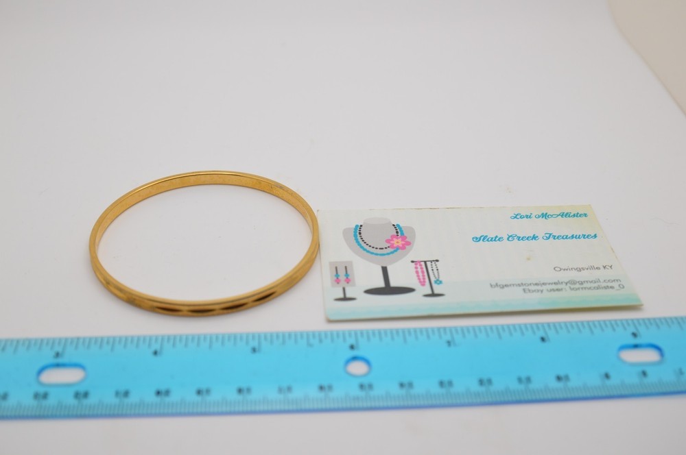 Thin gold bangle bracelet, signed Monet, 163