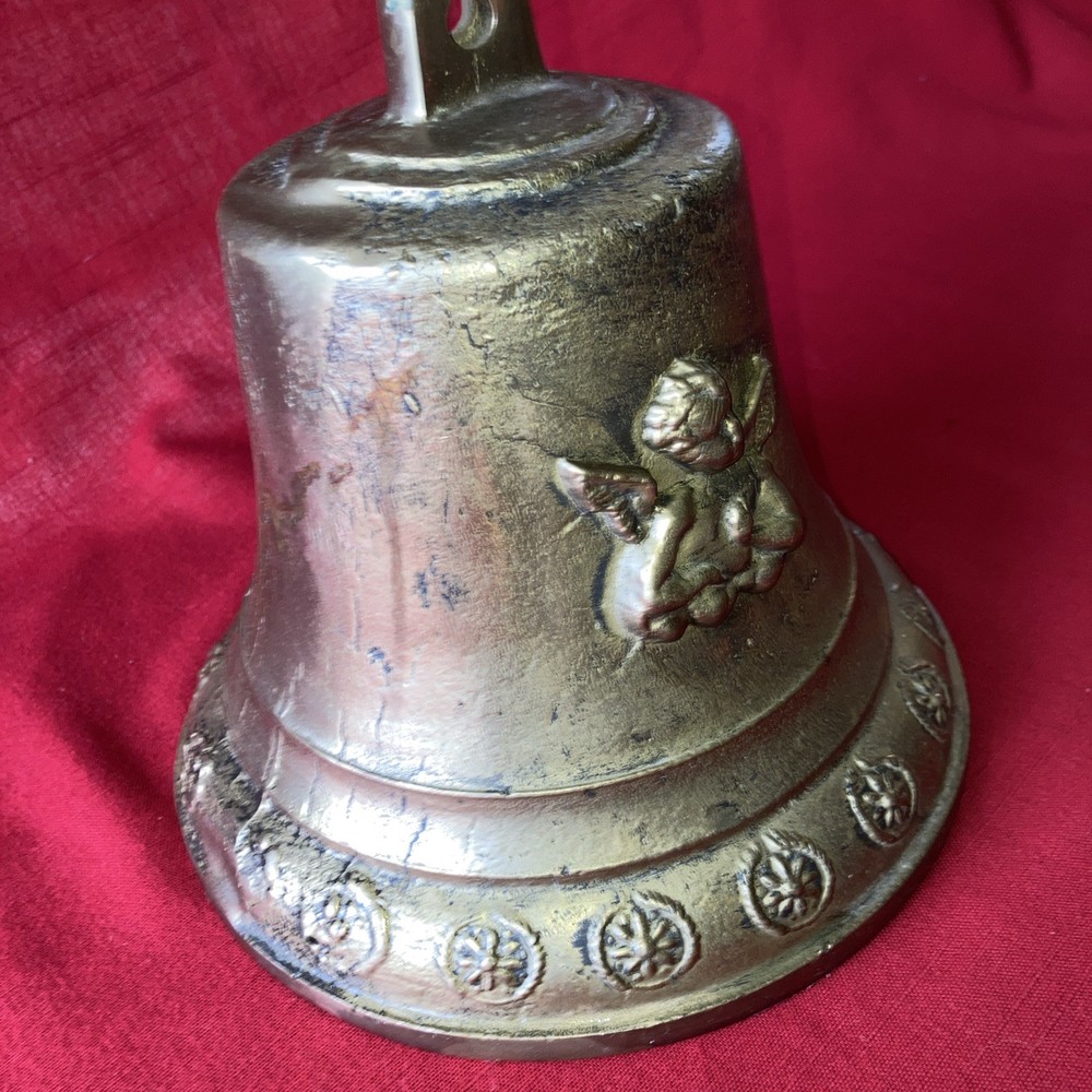 Heavy brass bell with Cupid on each side.