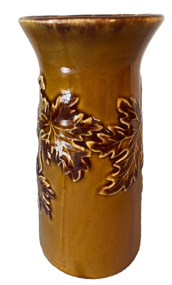 Handmade brown ceramic vase with leaves