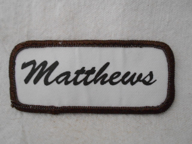 MATTHEWS  USED SILK SCREEN NAME PATCH TAG BROWN ON WHITE