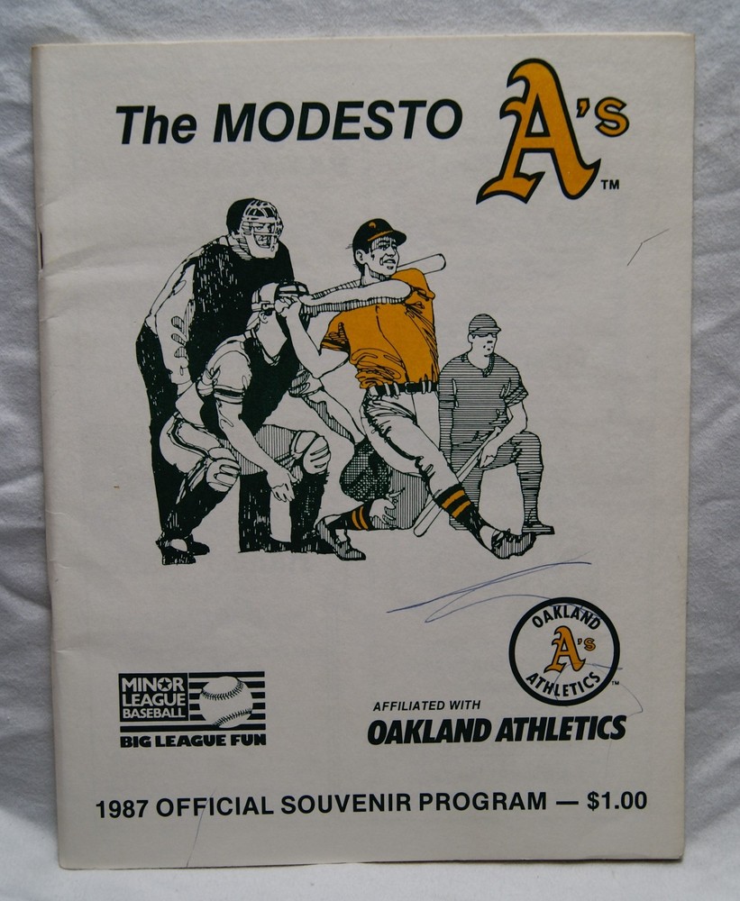 1987 modesto a's official souvenir program writing on cover