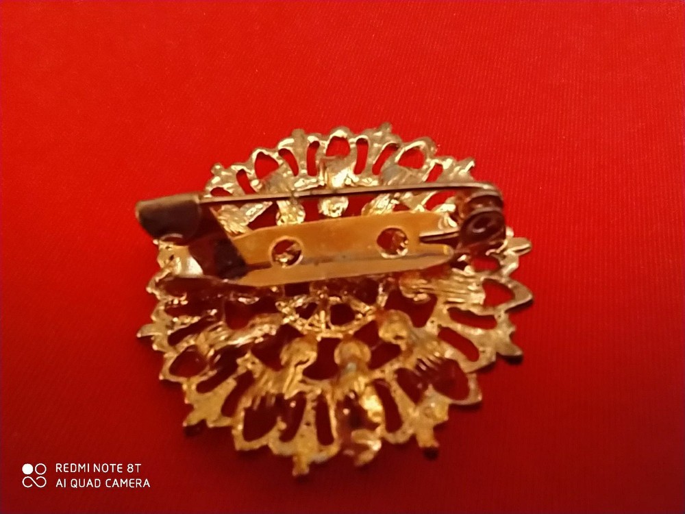 Base metal brooch with stones