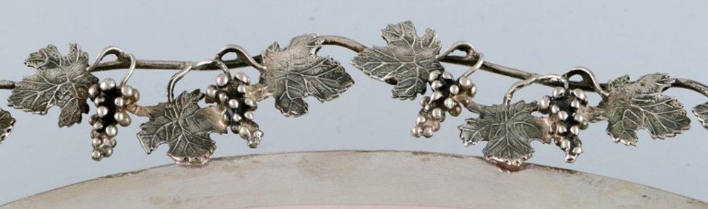 Large silver bowl pierced with grape vines.