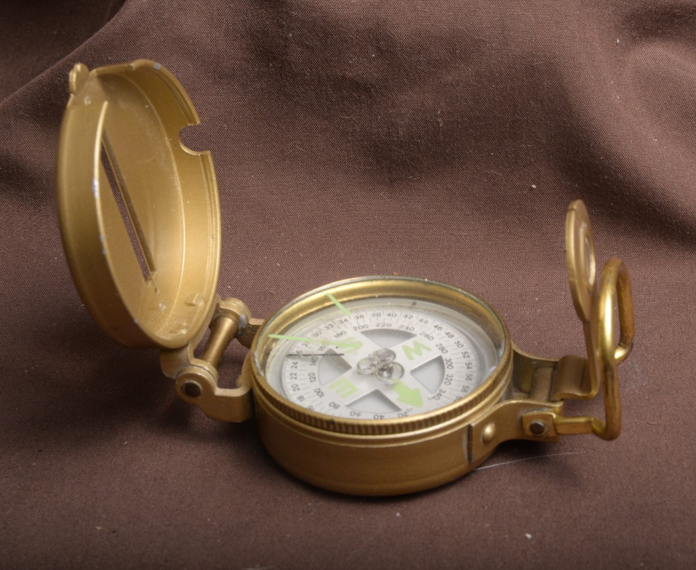 two lensatic compasses one with box