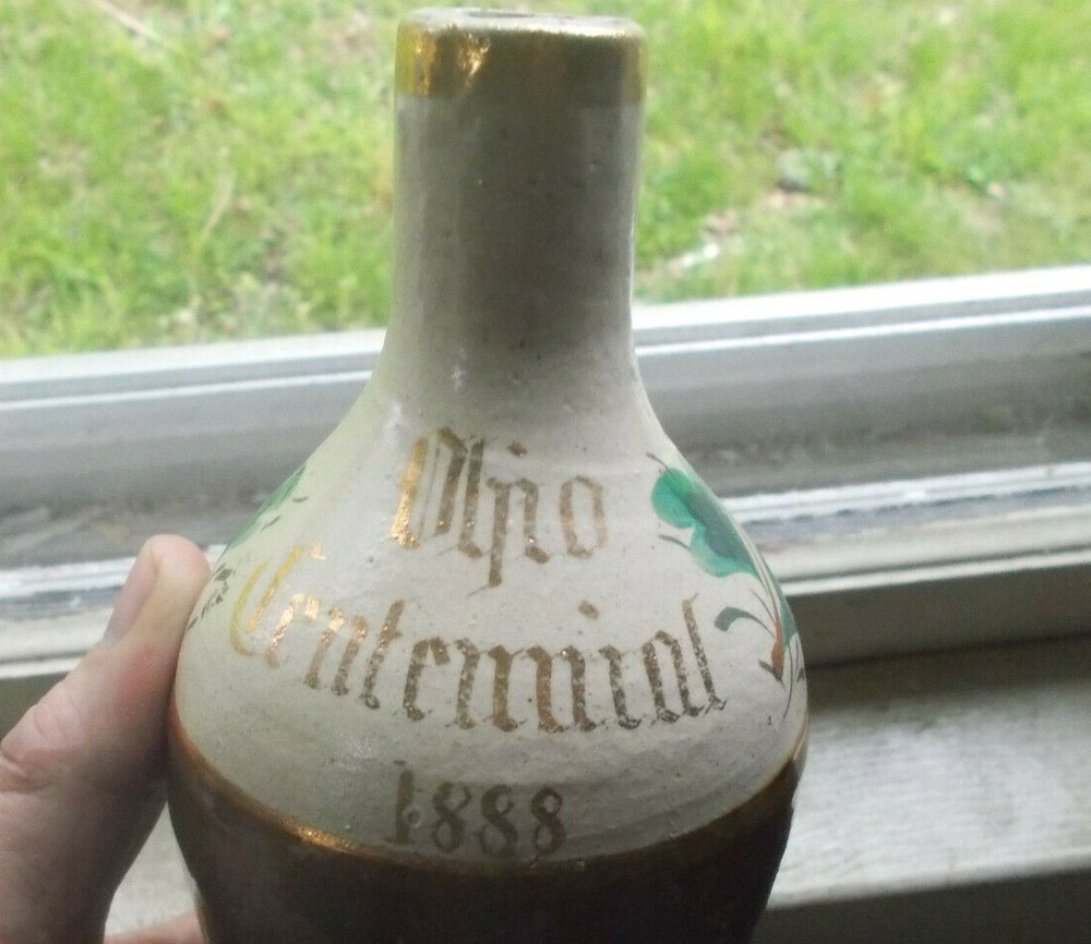 1888 DATED OHIO CENTENNIAL STONEWARE BOTTLE HAND PAINTED FLOWERS HANDLE BROKEN