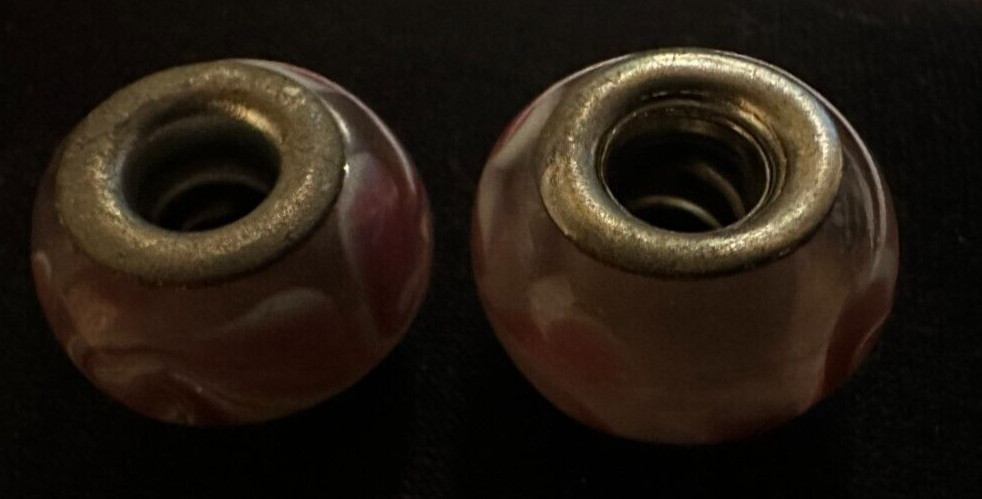 two matching pink patterned charms For Charm Braeclets
