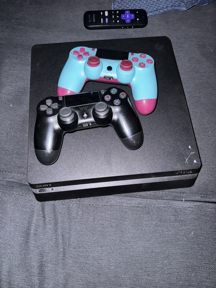 playstation 4 console used with 2 controllers