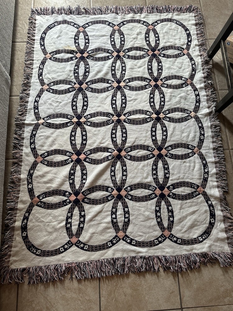 Woven Double Wedding Ring pattern blanket with fringe.