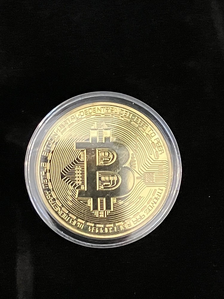 Bitcoin - gold colored Bitcoin in protective case.