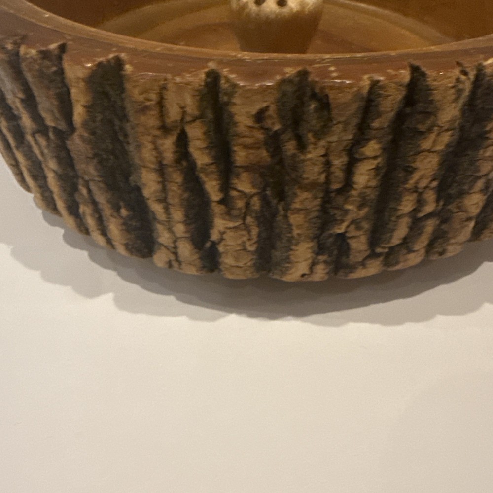 Vintage wooden nut bowl with rustic tree bark,