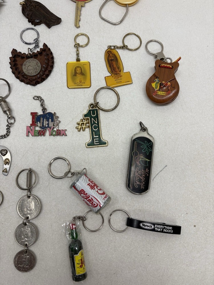 32 Vintage Key Chains And a John Deere Tin Box