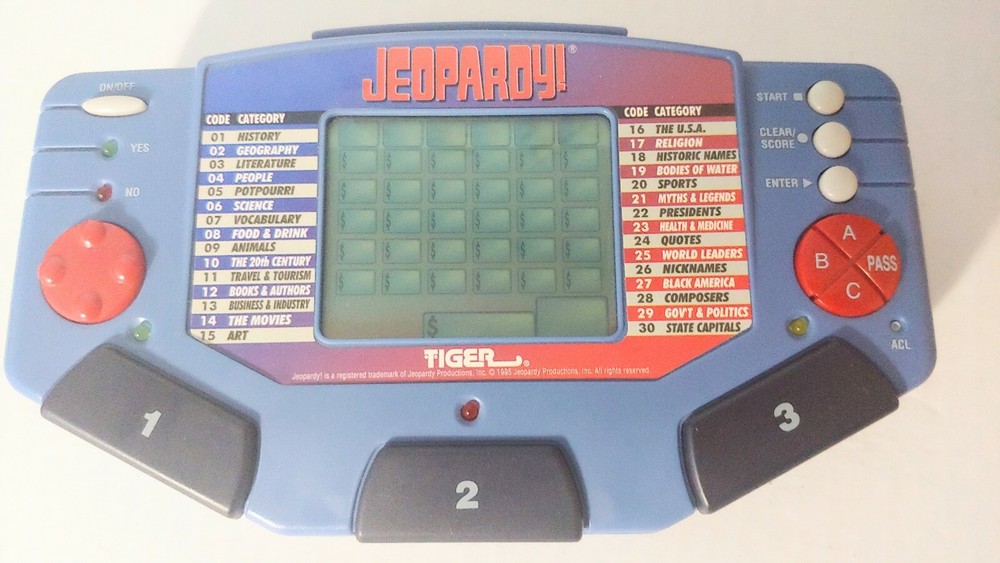 Jeopardy Handheld Electronic Game Complete with Answer/Question Book & Cartridge