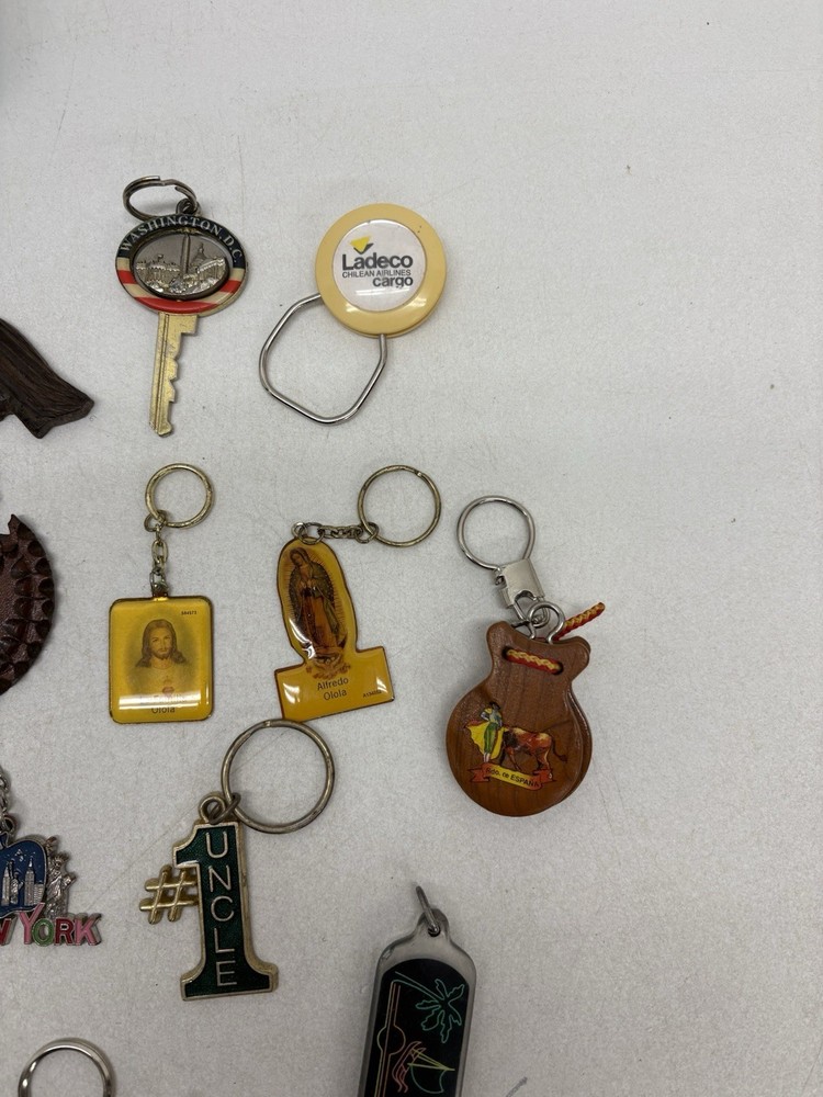 32 Vintage Key Chains And a John Deere Tin Box