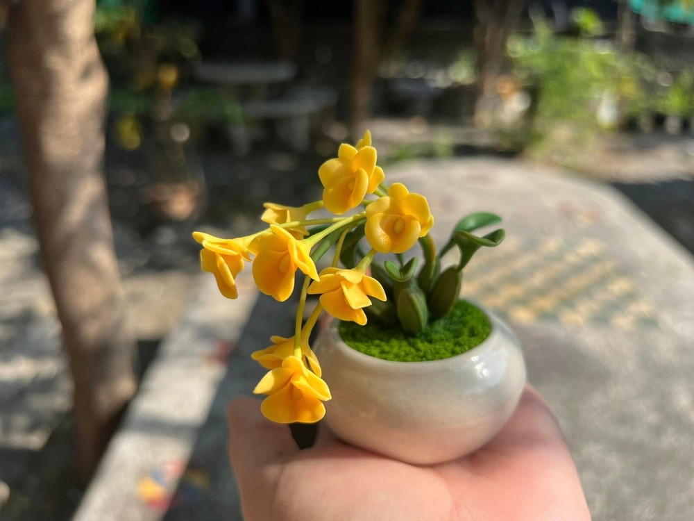 Tiny yellow orchids made by hand from clay