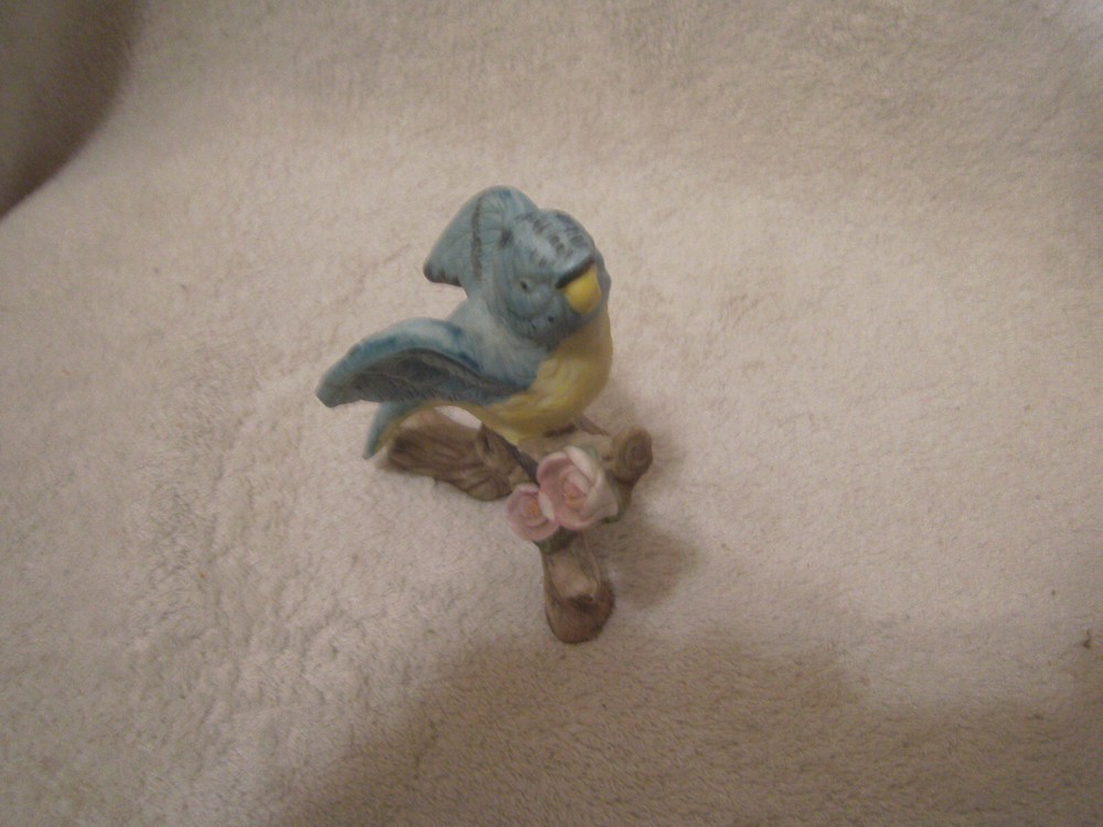 Blue ceramic parrot on tree branch 4 1/2 inches tall