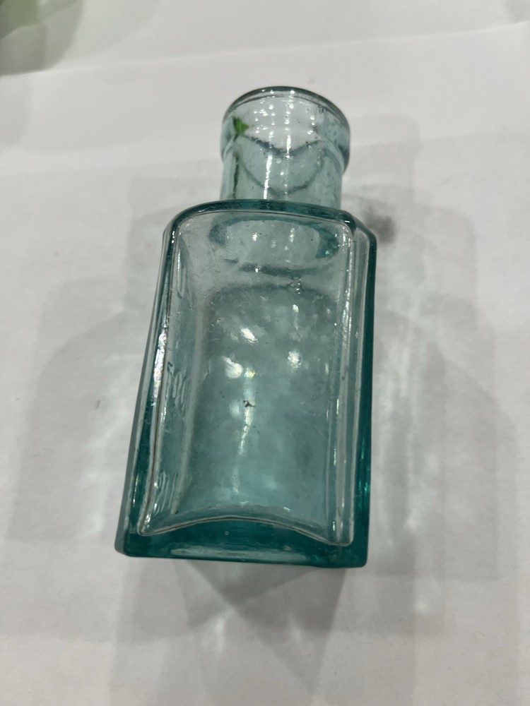Embossed Aqua Kavu Boot Polish Bottle