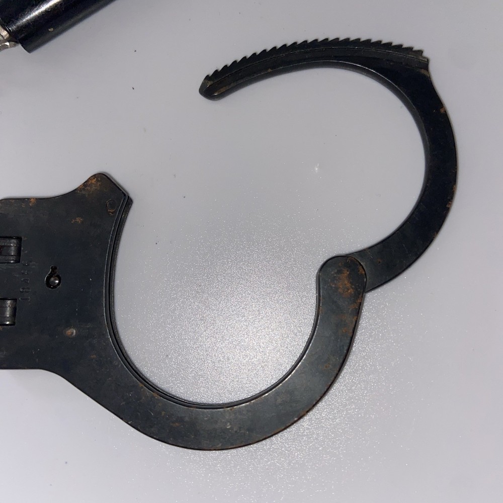 Vintage Peerless Hinge-Linked Handcuffs & Key On Monadnock Persuader