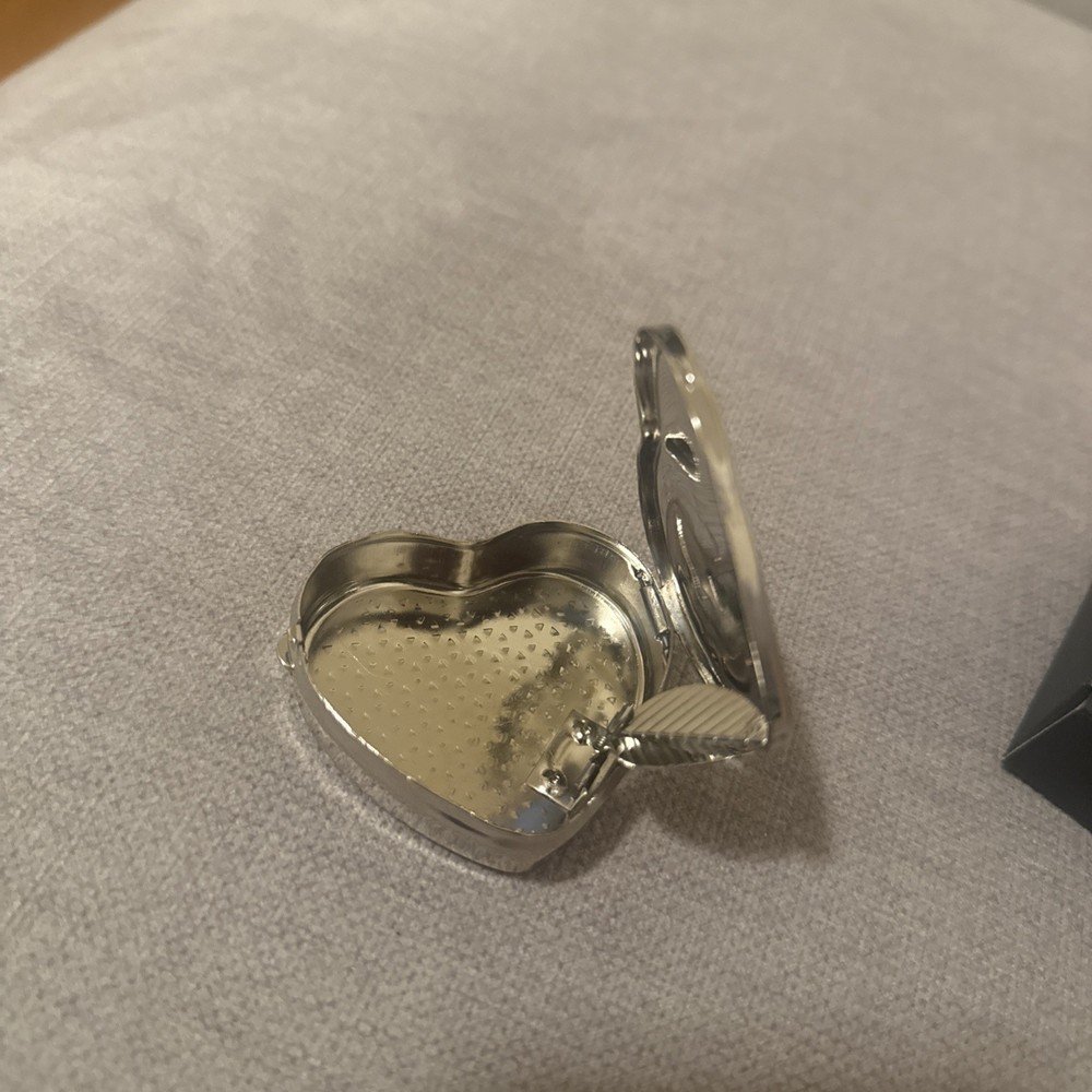 silver color pill box heart shape with leaf