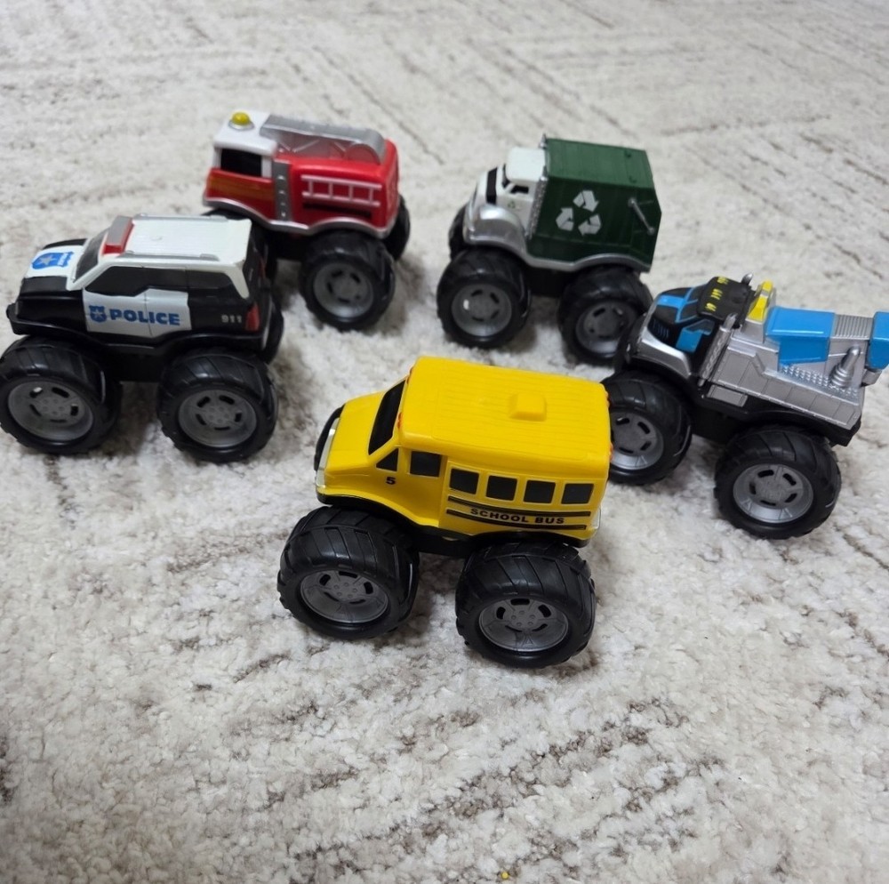 Set of 5 plastic trucks .