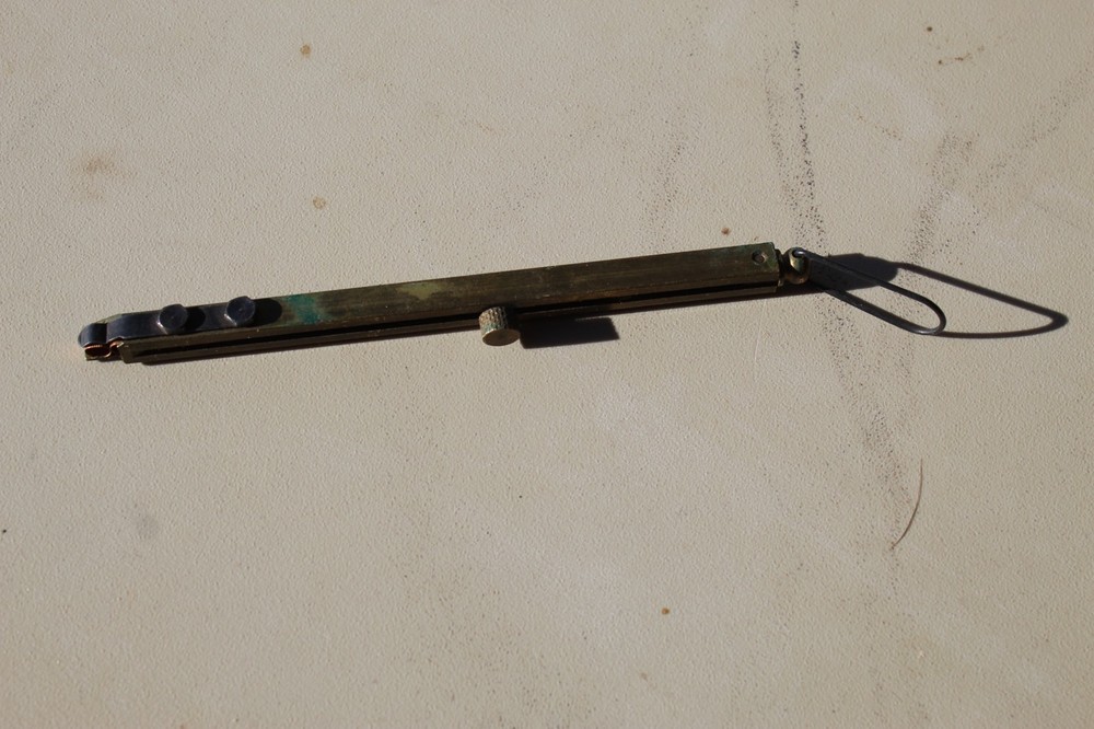 Brass straight-line percussion capper