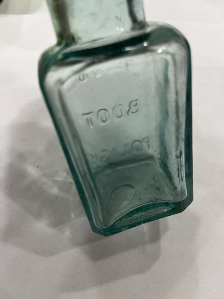 Embossed Aqua Kavu Boot Polish Bottle