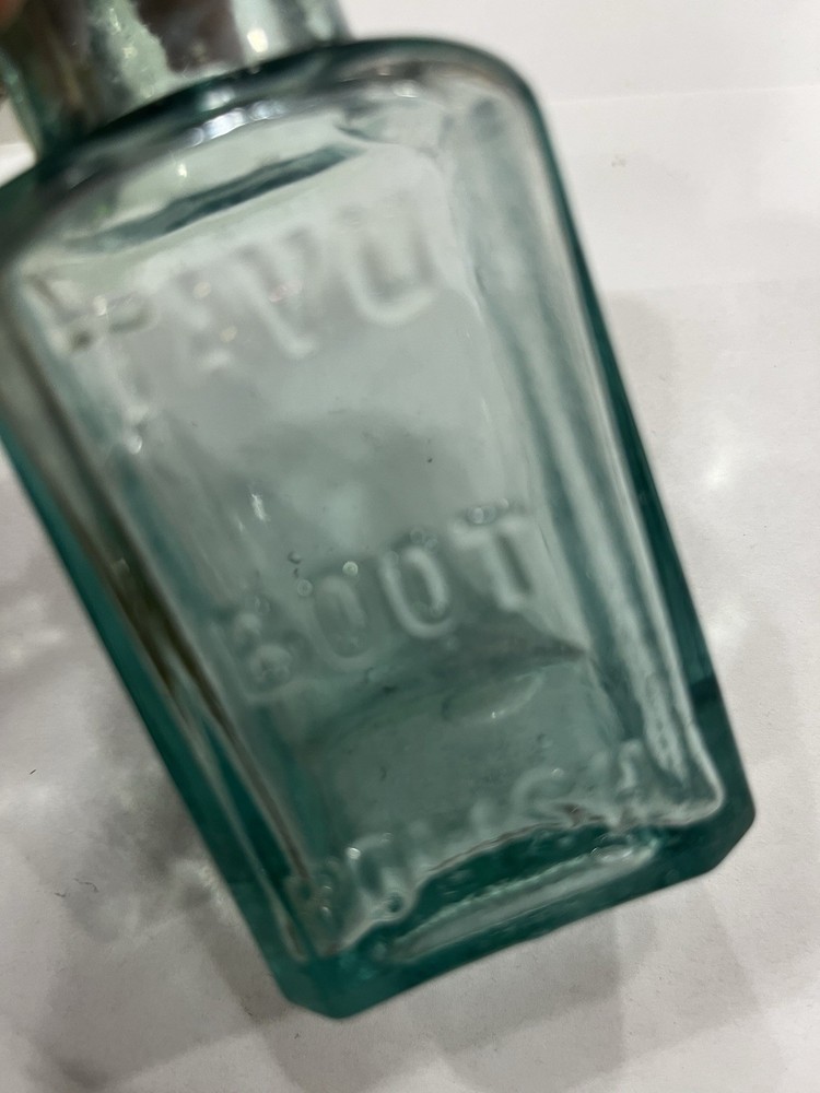 Embossed Aqua Kavu Boot Polish Bottle