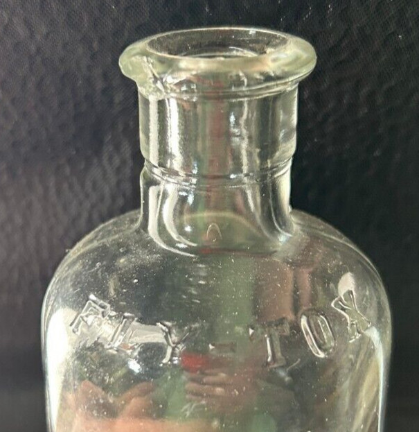 Clear small Fly Tox bottle with cork