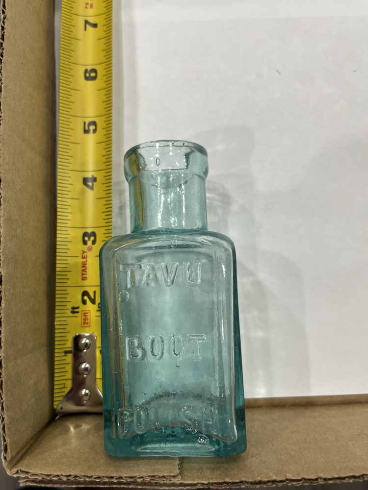 Embossed Aqua Kavu Boot Polish Bottle
