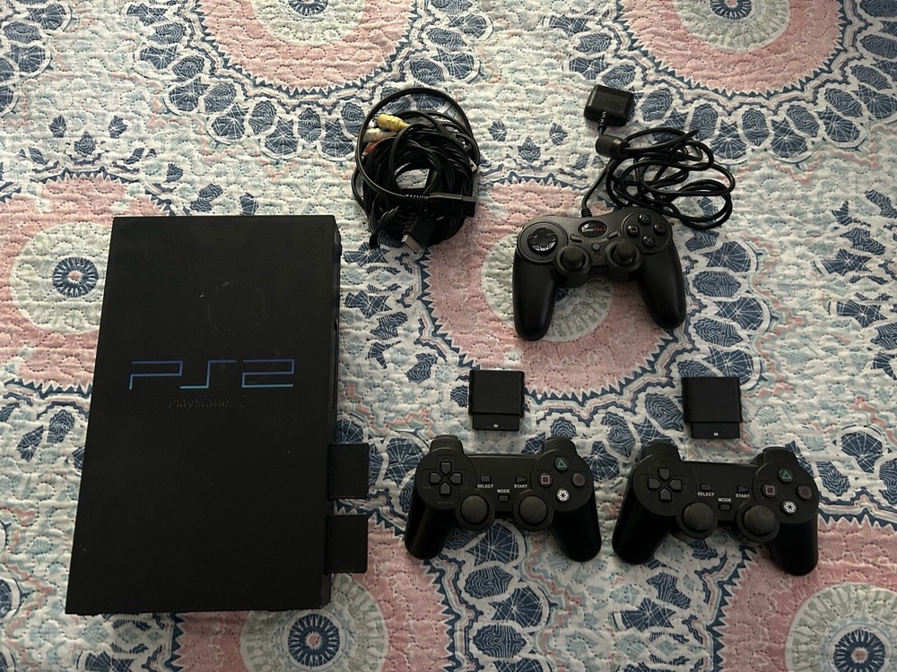 playstation 2 . The console , three controls with various games.