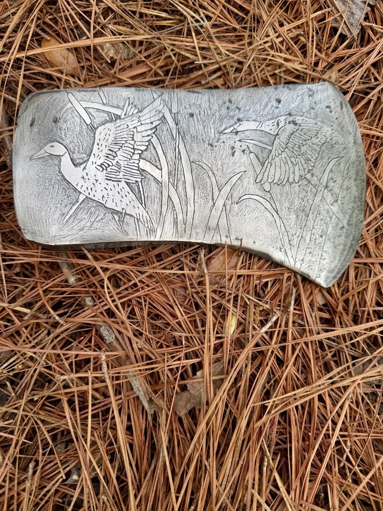 Single Bit Axe With A Duck Scenery Etched On Both Sides.